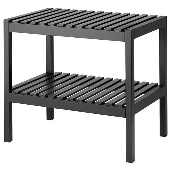 Un banc de rangement en bois nommé MUSKAN. Il est gris foncé, rectangulaire, avec deux étagères ouvertes pour le stockage, adapté aux zones à forte humidité.