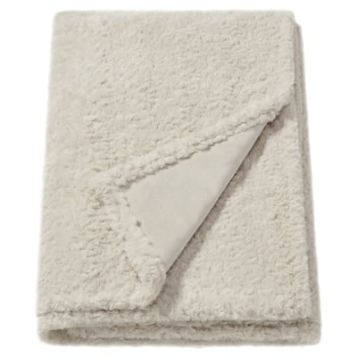 Couverture moelleuse blanc cassé, texturée, rectangle plié, fabriquée à partir de polyester recyclé doux.