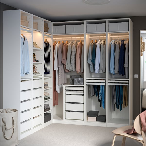 Armoire d’angle avec étagères, penderie, vêtements et rangement.