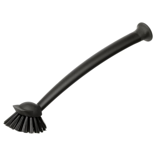 Brosse de cuisine noire avec manche long et ventouse pour frotter les surfaces.