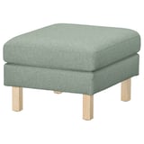 Un ottoman SALTSJÖBADEN en tissu vert avec des pieds en bois.
