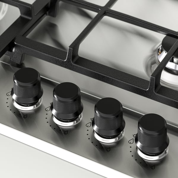 Quatre boutons élégants sur une plaque de cuisson à gaz en acier inoxydable. L’ingénierie de précision garantit une cuisson robuste et sans oscillation.