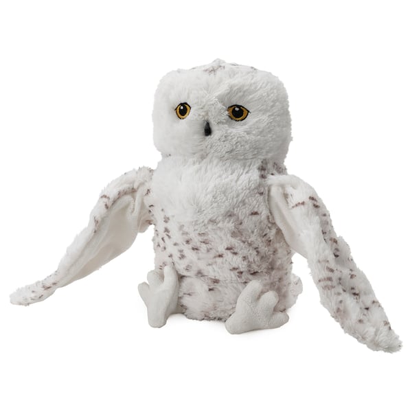 Un jouet hibou blanc en peluche avec des taches brunes, une texture douce et de grands yeux jaunes, parfait pour les enfants.