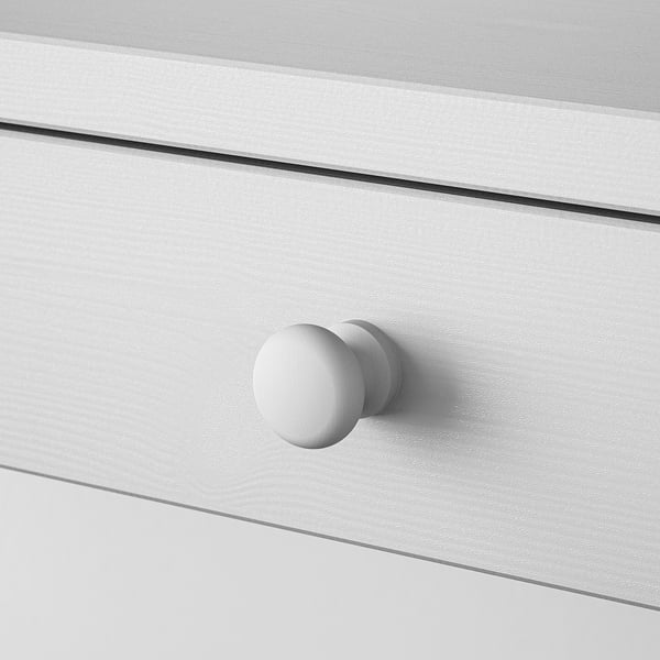 Boutons ronds et blancs sur un tiroir élégant et lisse ; Design minimaliste, construction robuste.