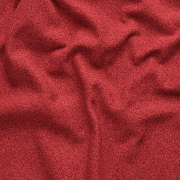 Tissu rouge doux en gros plan, texturé avec un effet bicolore. Affiche la qualité et la durabilité.