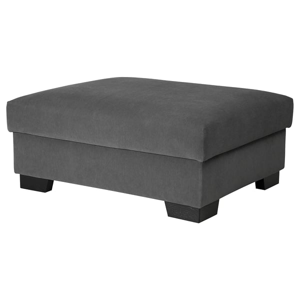 Le repose-pieds SÖRVALLEN est gris, rectangulaire avec une façade inclinée. Il est recouvert d’un tissu texturé gris. Quatre pieds en bois le soutiennent.