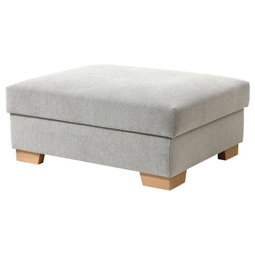 Un repose-pieds SÖRVALLEN gris avec des pieds en bois et des rangements.