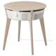 Une table de purification d’air STARKVIND blanche et en bois avec des pieds en bois clair et un plateau rond.