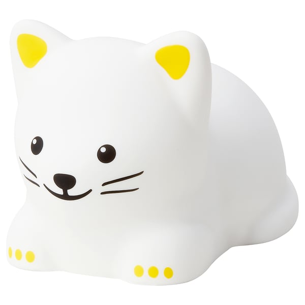 Veilleuse chat TÖVÄDER blanche aux accents jaunes, en silicone et plastique, conçue pour les enfants.