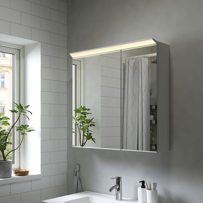 Armoire de toilette TREASJÖN grise moderne avec éclairage led et grande réflexion.