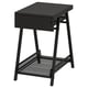 Un meuble de rangement TROTTEN noir avec un tiroir et une étagère grillagée, idéal pour les petits et les gros objets.