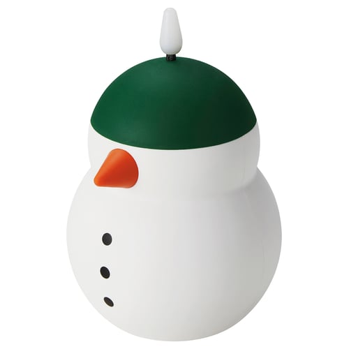Lampe en forme de bonhomme de neige avec un chapeau vert, nez orange et yeux noirs. Corps rond, blanc avec un minuteur de 6 heures.