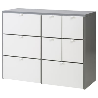 Une commode VISTHUS moderne, blanche avec un plateau gris, dotée de 6 tiroirs.