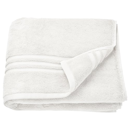 Elegante witte biologische katoenen handdoeken netjes gelegeld. Zacht, absorberend met een getextureerde rand. Ideaal voor gebruik in de badkamer.