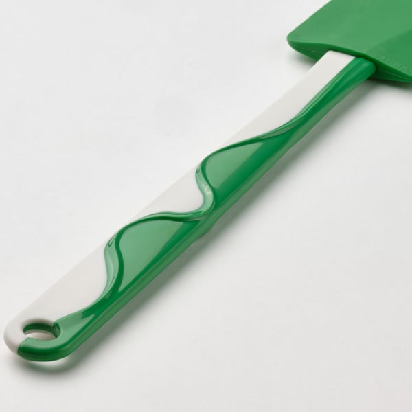 Groene spatel met wit patroon, flexibel mes, ergonomisch handvat.