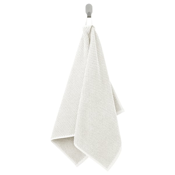 GULVIAL beige katoenen handdoek, zacht getextureerd, rechthoekig, hangt aan de haak.