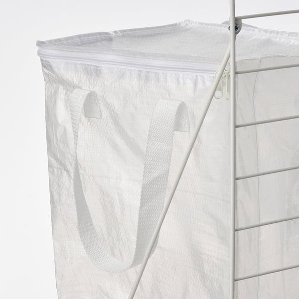 Witte opbergtas met rits en handvatten op metalen frame.