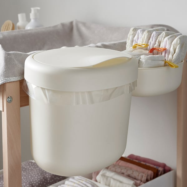 Witte wandbakken in een badkameromgeving. Ze bewaren en ordenen babyverzorgingsartikelen, luiers en handdoeken efficiënt.