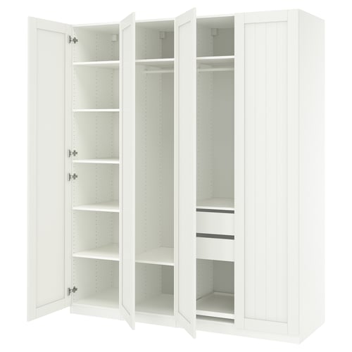 Een witte ikea PAX kledingkast met open deuren, die lege planken en lades onthullen.