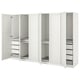 Witte ikea PAX kledingkast met open deuren met planken en organizers binnenin.