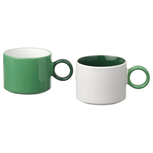 Twee groene en witte mokken met ronde handvatten, contrasterende kleuren.