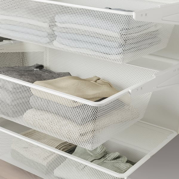 Witte mesh opberglade uitgetrokken, gevuld met opgevouwen kleding, met organisatiefunctie.