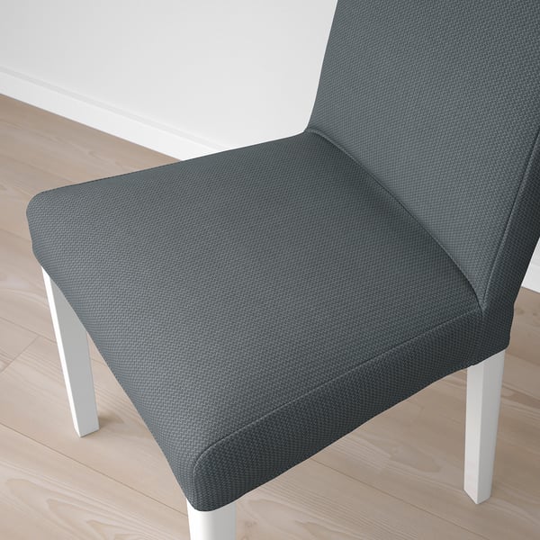 Modern upholstered chair with grey patterned fabric, white legs. Comfortable and stylish for dining.