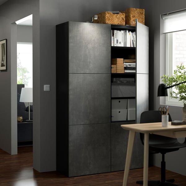 Modern home office with BESTÅ storage unit, desk, and lamp.
