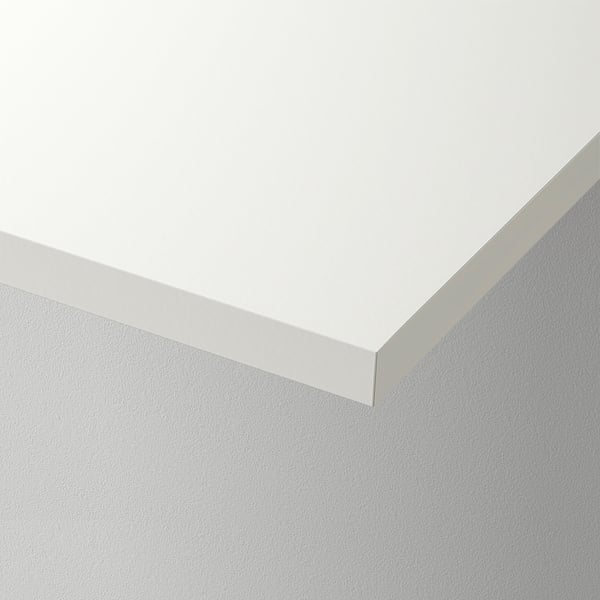 Clean, white corner of a modern, minimalist wall shelf, showcasing its sleek and seamless design.
