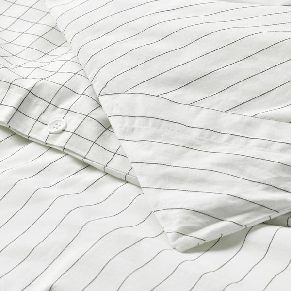 White duvet cover with stitched check pattern and stripe sides, featuring buttoned corners for easy insertion.