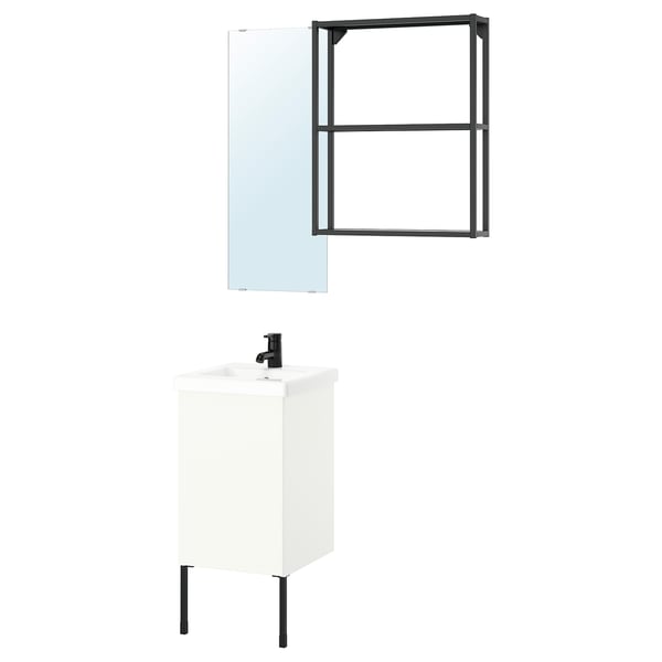 Modern white bathroom vanity with black accents and mirror.