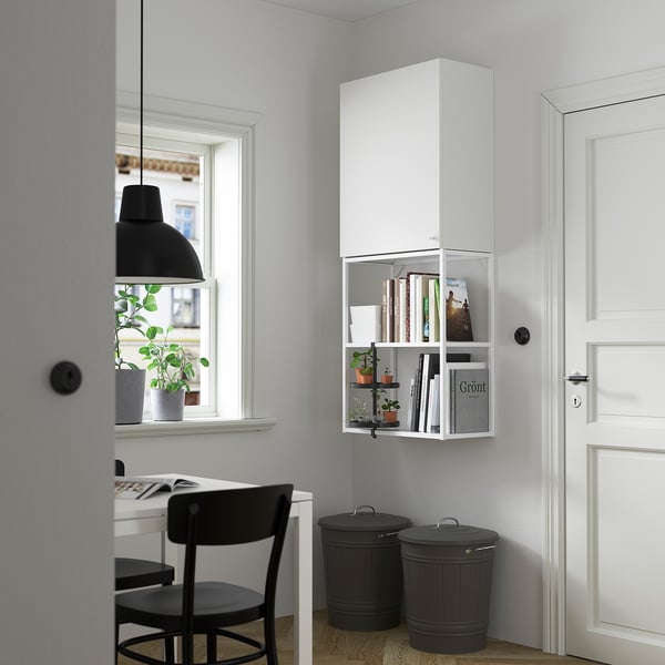 Modern home office: white ENHET wall cabinet, black bins, sleek desk & chair setup, minimalist decor.