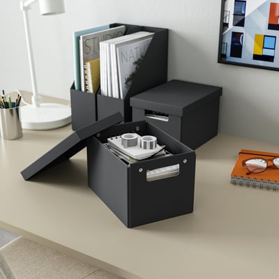 Three FJÄDERHARV boxes on desk: one open with containers, two closed with papers, silver handles.