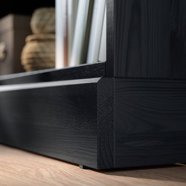 Black HAVSTA wooden shelf, made of solid pine with detailed edges. Displays books vertically, featuring a rustic, clean design.