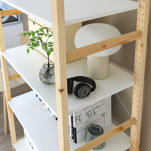IVAR shelf system with lamp, headphones, and plant.