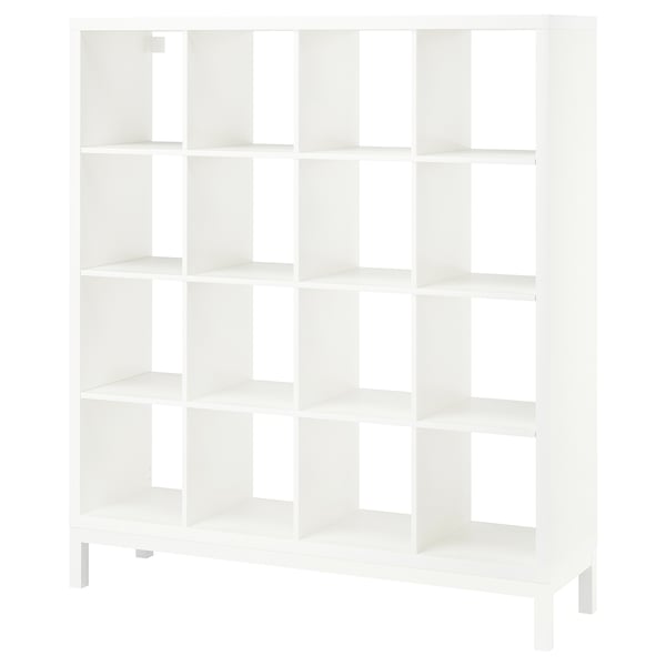 A KALLAX shelving unit in white. It has a modern design with multiple open cubes for storage. The unit stands on thin legs, giving it an airy look.