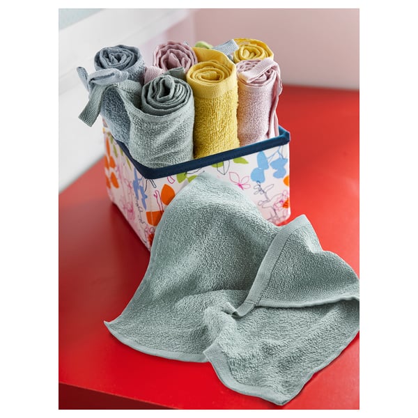 Coloured rolled towels in basket, grey towel out.