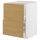 An ikea METOD kitchen unit with white and oak-colored drawers. Its modern minimalist design integrated handles.