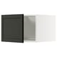 Modern black and white kitchen cabinet with dark door, sleek design.