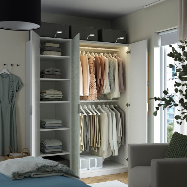 Organised closet with shelves and hangers. Clothes are neatly arranged, showcasing a functional storage solution.