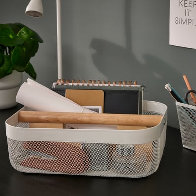 RISATORP white mesh desk organiser with wooden divider holds notebooks, papers, and pens, suitable for various spaces.