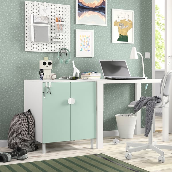 Small home office with SMÅSTAD light green cabinet, white desk, modern decor, minimalist design, fitting well in cosy space.