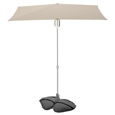 A light beige TVETÖ patio umbrella with a rectangular shape and a sturdy metal pole, supported by a weighted base.