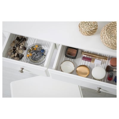 Vanity drawer with jewellery, makeup, brushes, and containers neatly organised.