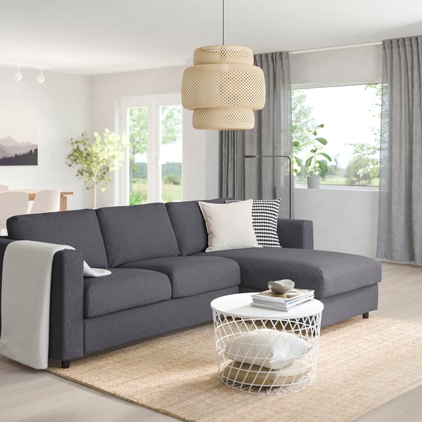 Modern living room with grey VIMLE sectional sofa, white coffee table, and large window.
