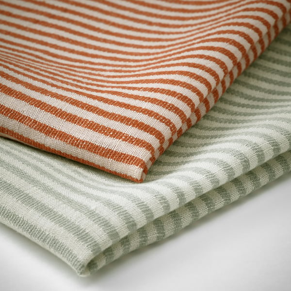 Striped linen tea towels with elegant patterns. Textures are crisp and refined, highlighting quality and absorbency.