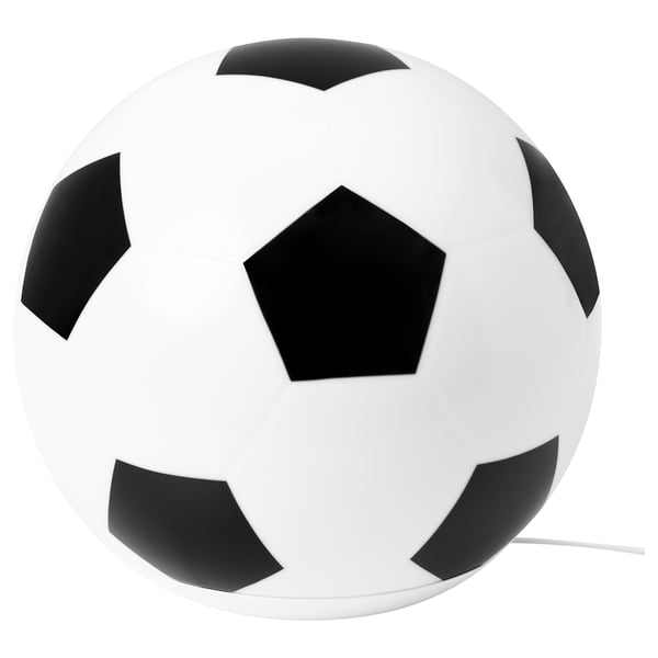 A white and black football-shaped table lamp. Its round with pentagon and hexagon patterns, made of plastic, and emits a soft light.