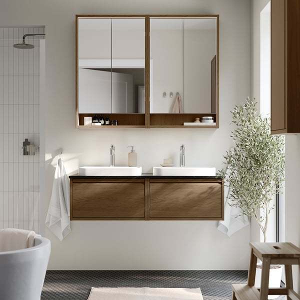 Modern bathroom with oak dual vanity, two basins, large mirror, wall-mounted, sleek design.