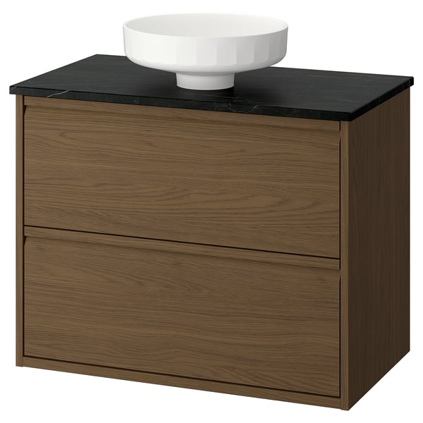Elegant oak wooden bathroom vanity with black countertop and round white basin. Minimalist design with integrated handles.