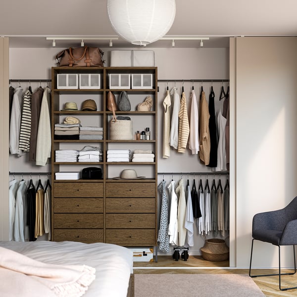 Modern organised closet with AURDAL wooden shelves and drawers, hanging clothes, and accessory storage.